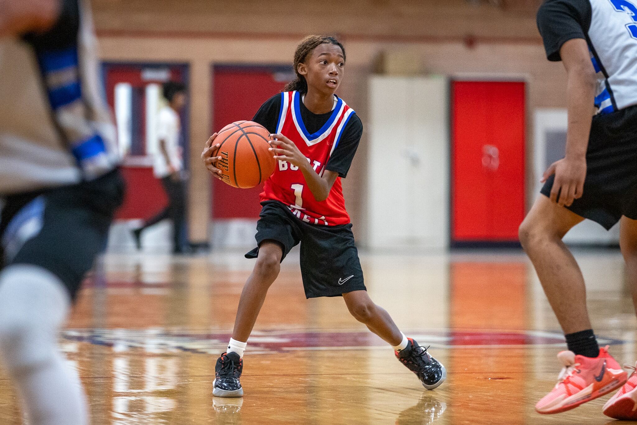 A Booth-Fickett players dodges his competitors on the court