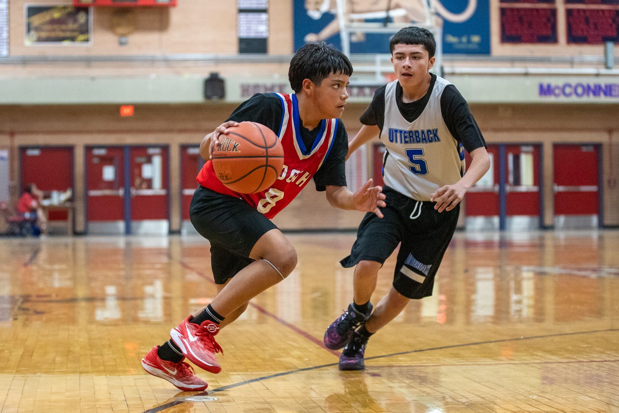 A Booth-Fickett player dribbles the ball past an opponent