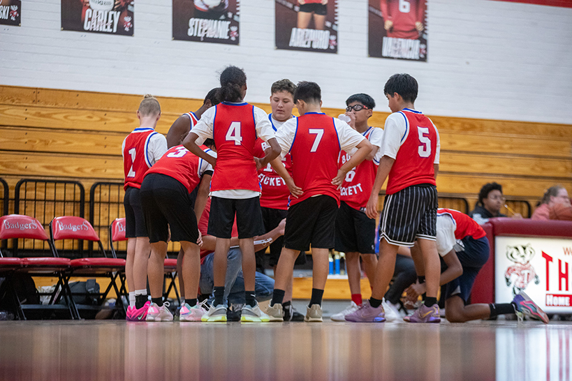 The Booth-Fickett basketball team goes into a huddle