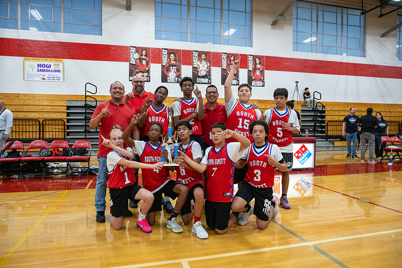 The Booth-Fickett boys basketball team celebrates their win