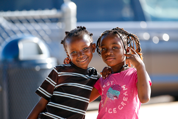 Two young girls smile for a photo