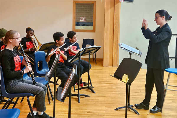 A woman directs the middle school band