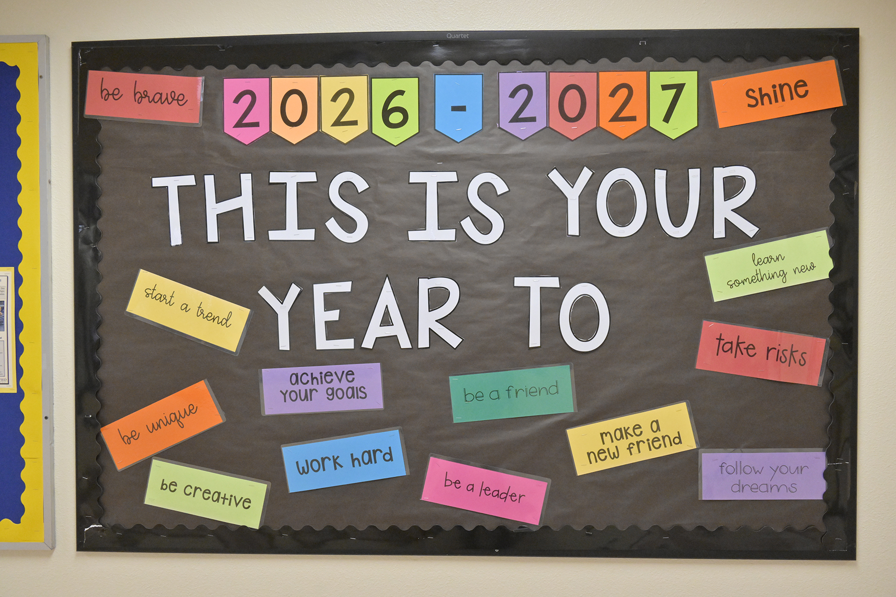 A bulletin board with the words This Is Your Year To