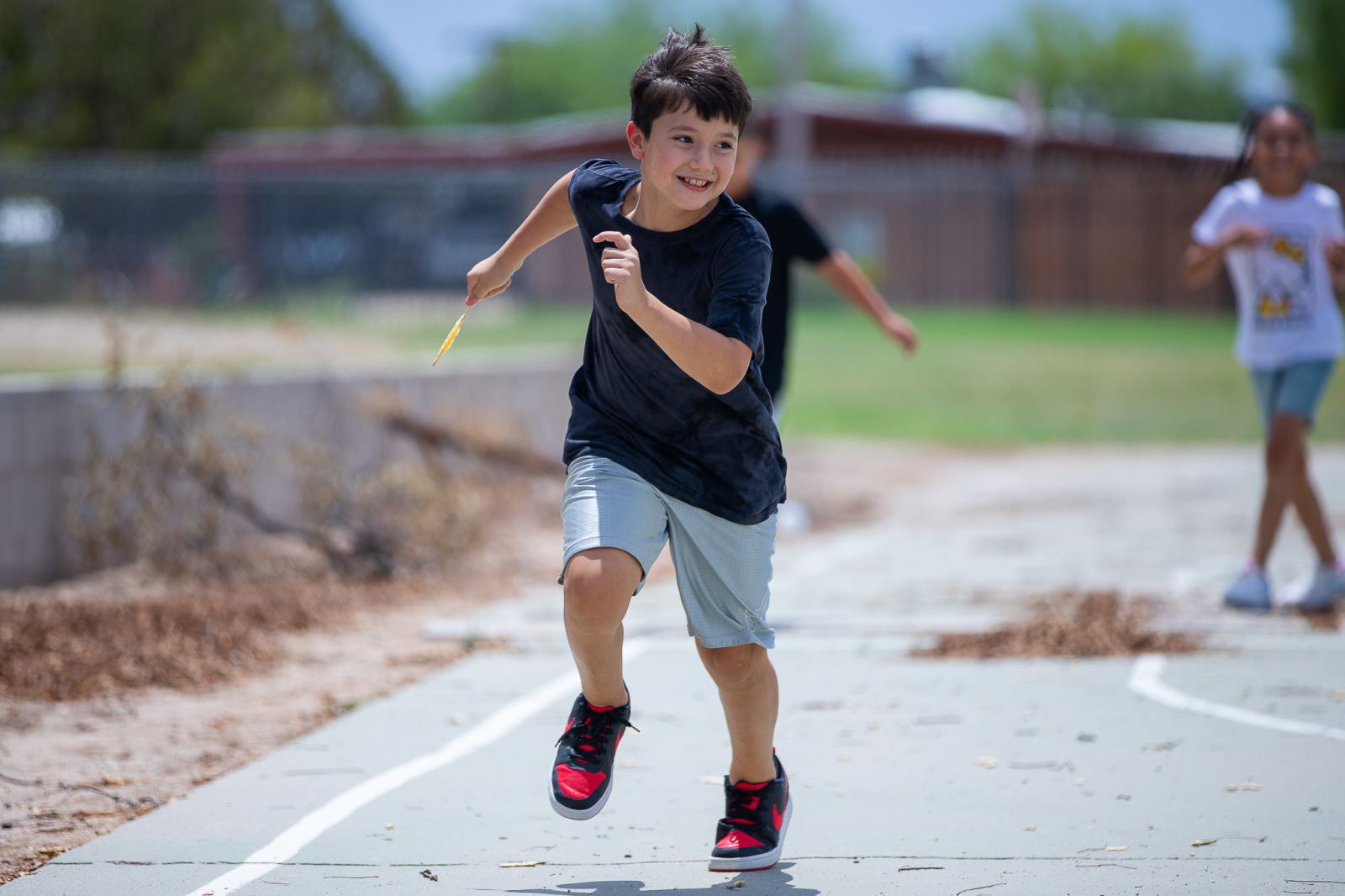 A student has fun running during recess.