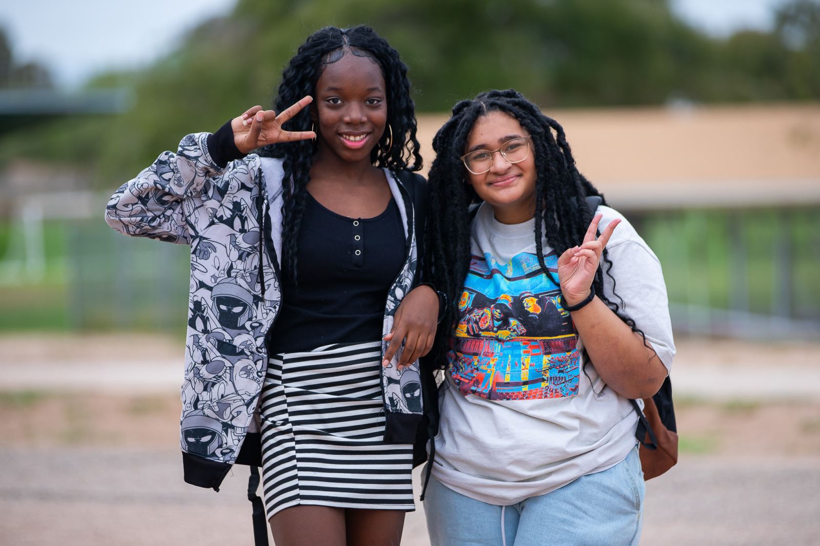 Two girls give peace signs on the Booth-Fickett campus